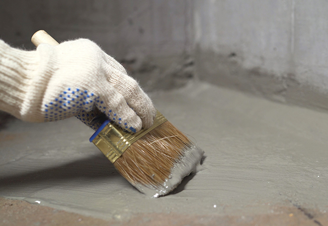 Cementitious waterproofing material for water damage protection