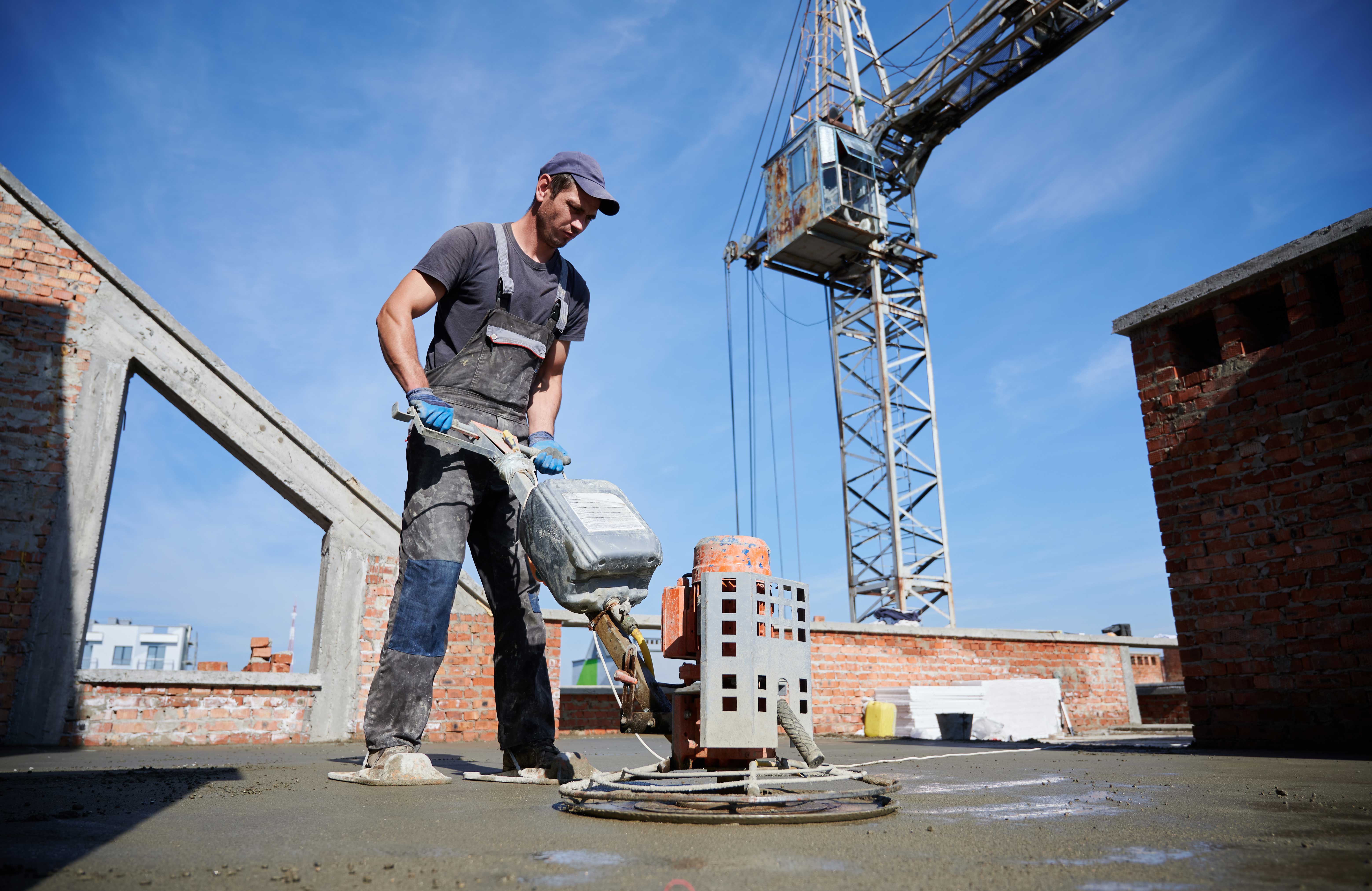 worker-leveling-fresh-floor-with-special-machine